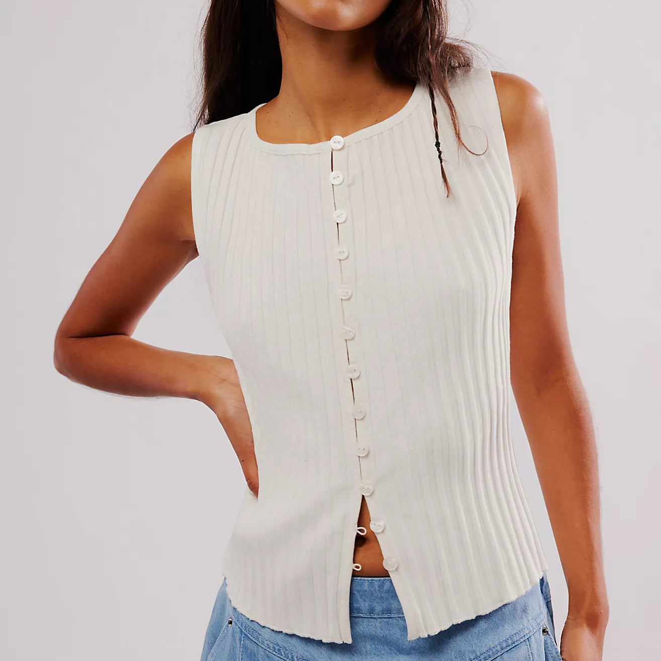 Free People Tilly Vest made from a soft, textured fabric with a relaxed, sleeveless design. This button-front vest offers a stylish and lightweight layering piece, perfect for adding a chic touch to any outfit, Ivory