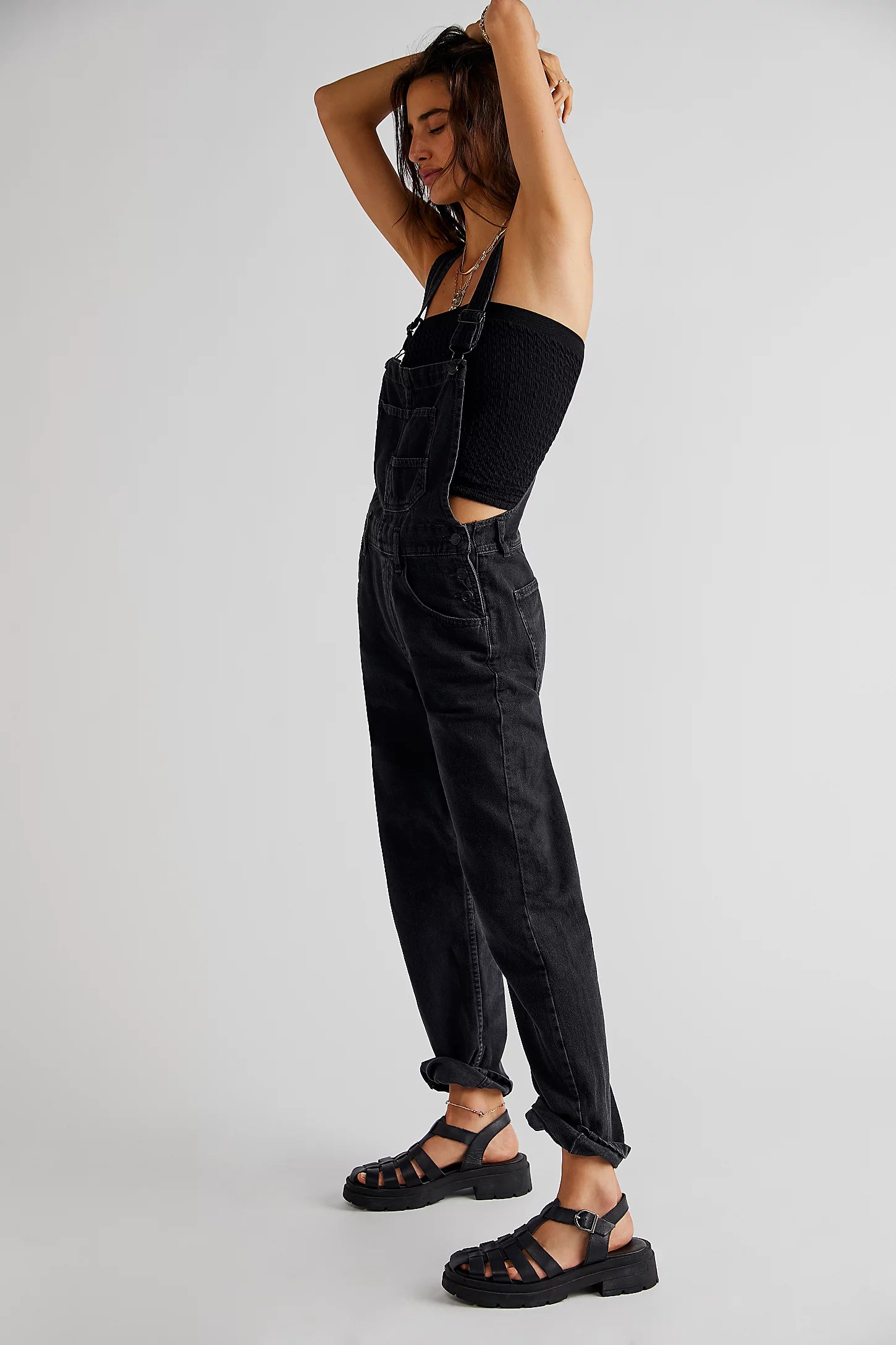 We The Free Ziggy Denim Overalls featuring a relaxed, vintage-inspired fit with wide legs and a distressed, worn-in look. The overalls have adjustable shoulder straps, a front bib pocket, and a button-up closure, offering both style and comfort for everyday wear, Mineral Black