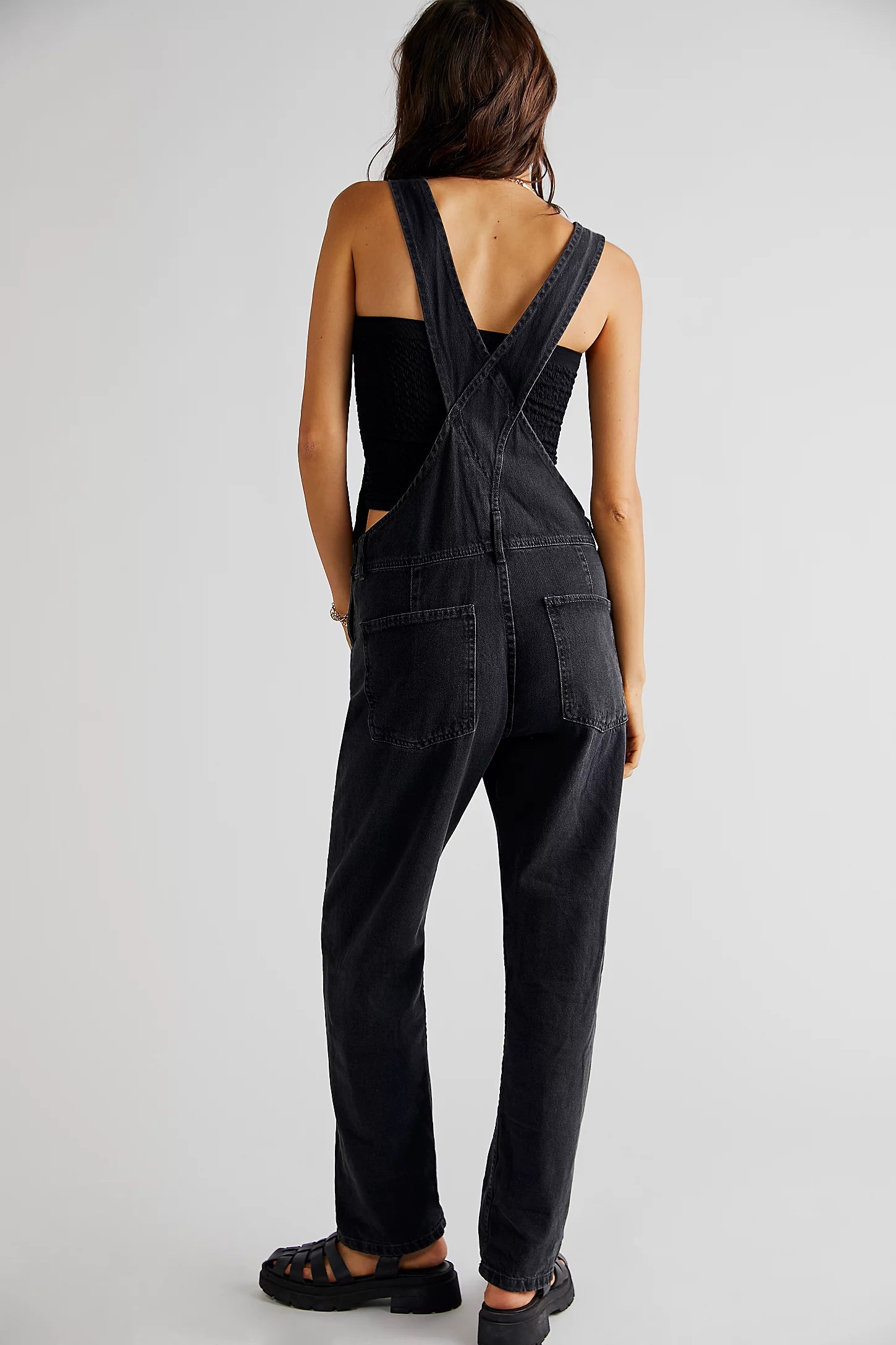 We The Free Ziggy Denim Overalls featuring a relaxed, vintage-inspired fit with wide legs and a distressed, worn-in look. The overalls have adjustable shoulder straps, a front bib pocket, and a button-up closure, offering both style and comfort for everyday wear, Mineral Black