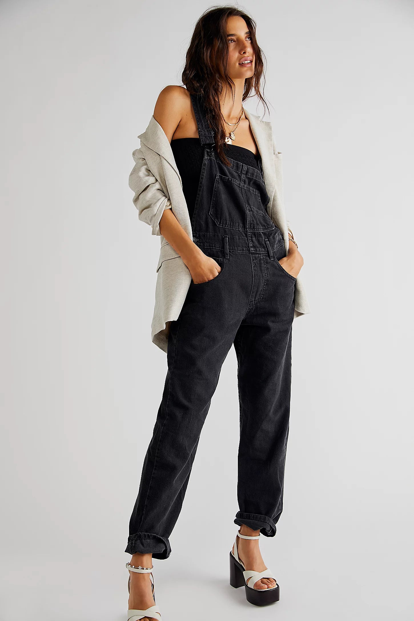 We The Free Ziggy Denim Overalls featuring a relaxed, vintage-inspired fit with wide legs and a distressed, worn-in look. The overalls have adjustable shoulder straps, a front bib pocket, and a button-up closure, offering both style and comfort for everyday wear, Mineral Black