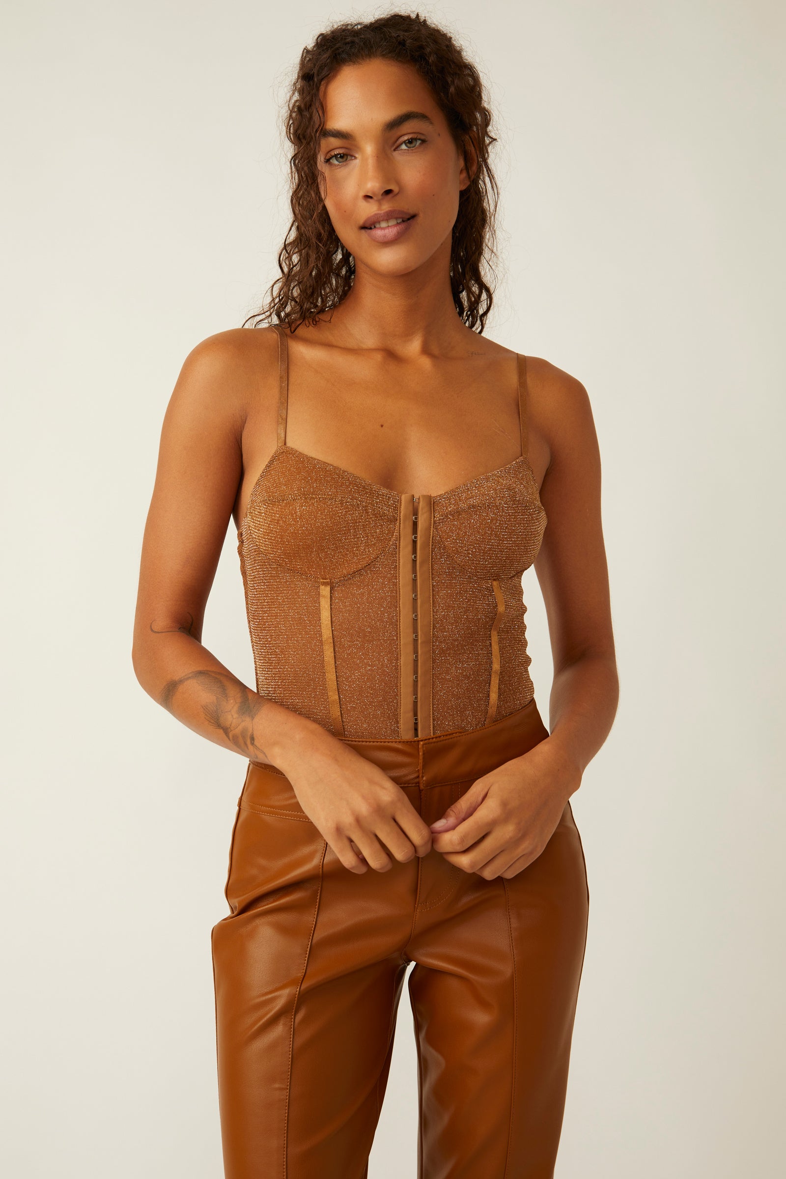 Free People Shimmer Night Rhythm Bodysuit – A sleek, form-fitting bodysuit with a shimmery fabric and adjustable straps, perfect for a chic and glamorous look, Bronze