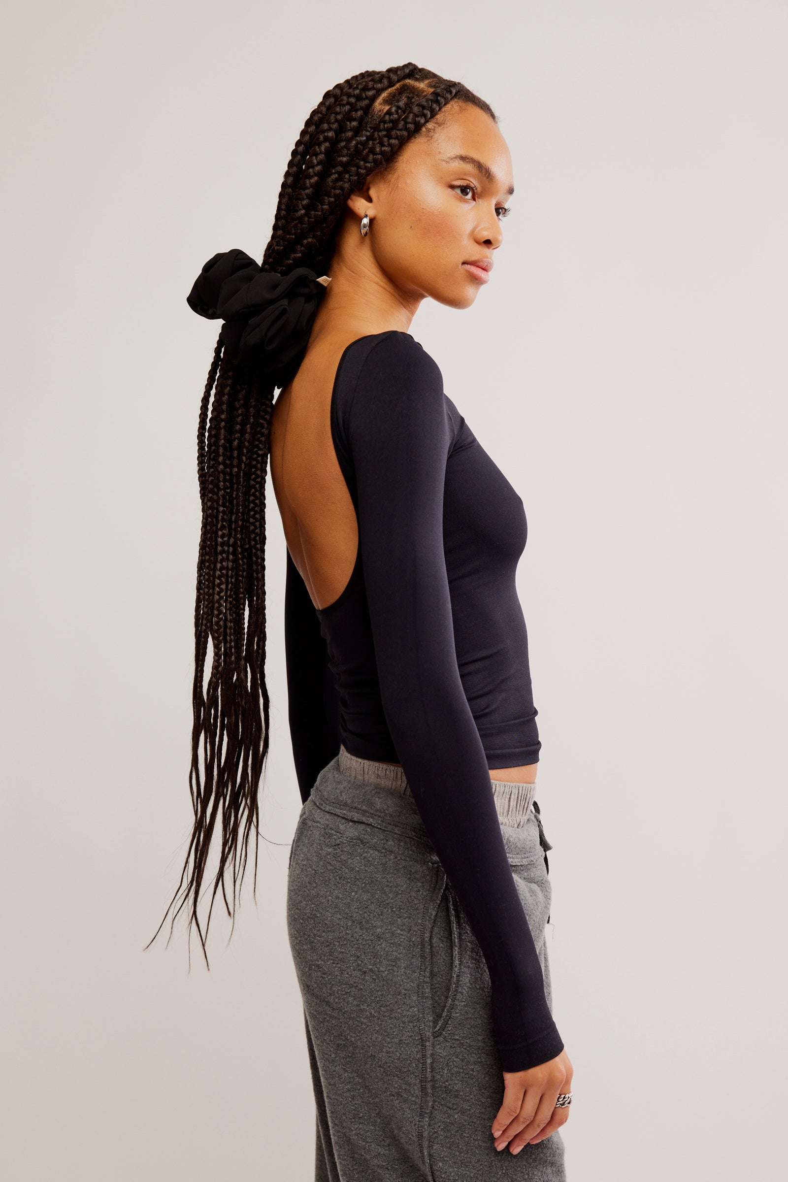 Free People Low Back Seamless Long Sleeve featuring a fitted design with a low back, made from soft, stretchy fabric for a comfortable and sleek look, Black