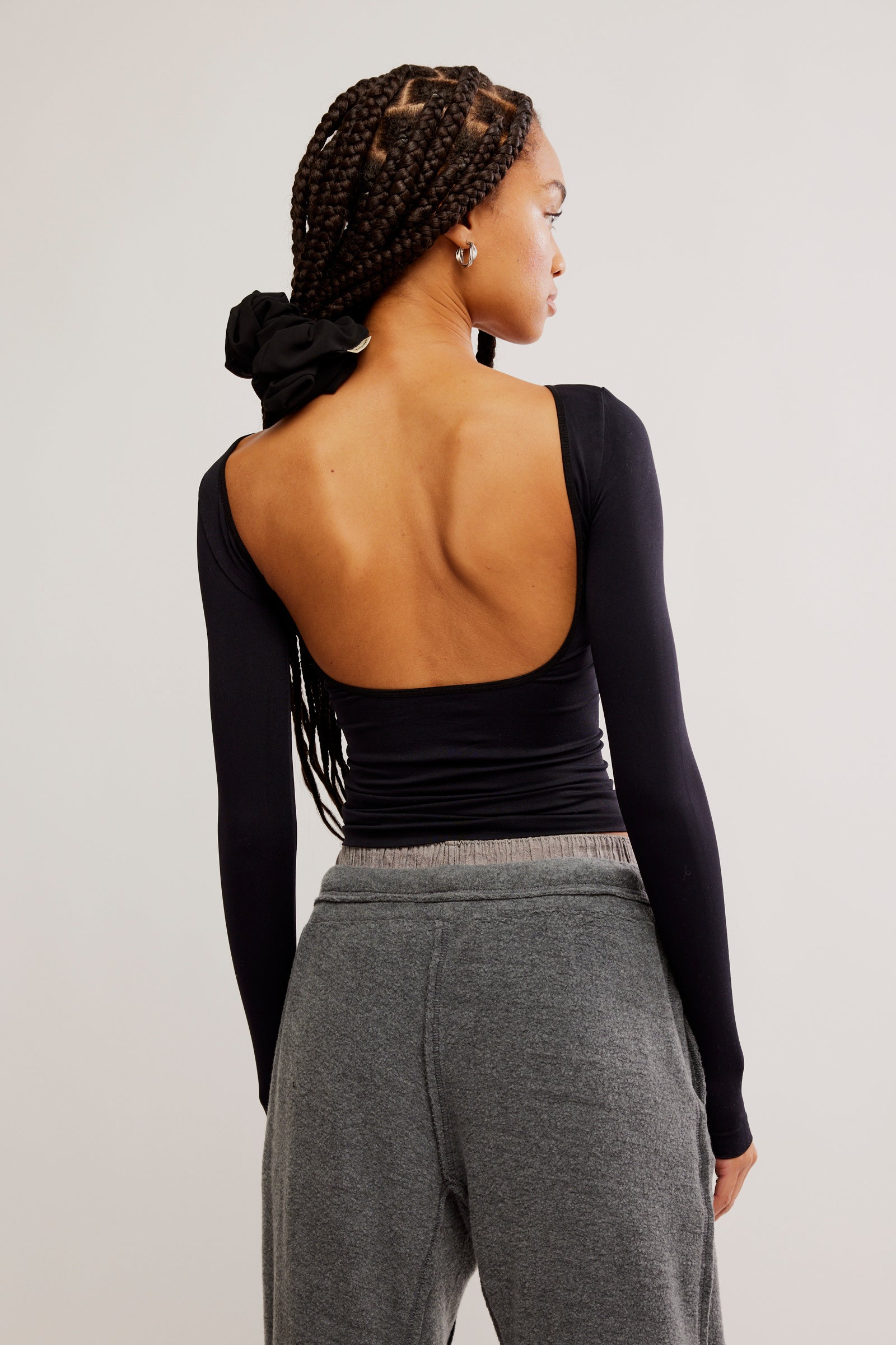 Free People Low Back Seamless Long Sleeve featuring a fitted design with a low back, made from soft, stretchy fabric for a comfortable and sleek look, Black