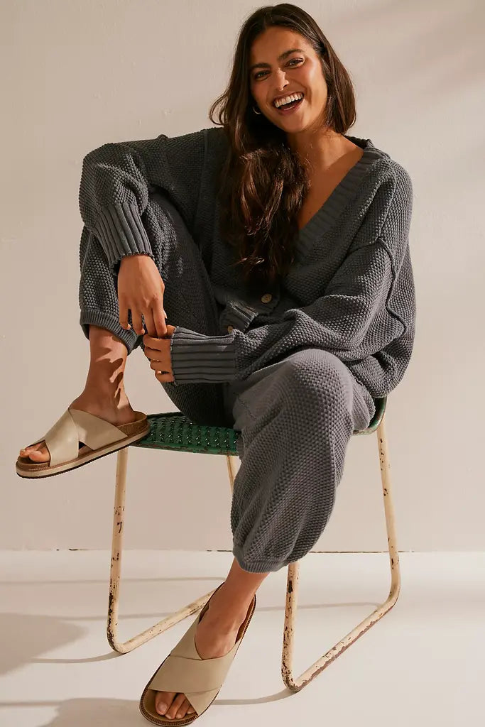Free People Hailee Cardi Set featuring a soft, knit fabric with a relaxed fit. The set includes a long-sleeve, open-front cardigan and matching knit pants, offering a cozy and stylish look, perfect for casual wear or lounging, Peppery