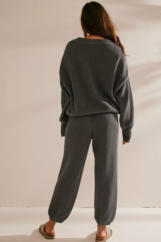 Free People Hailee Cardi Set featuring a soft, knit fabric with a relaxed fit. The set includes a long-sleeve, open-front cardigan and matching knit pants, offering a cozy and stylish look, perfect for casual wear or lounging, Peppery