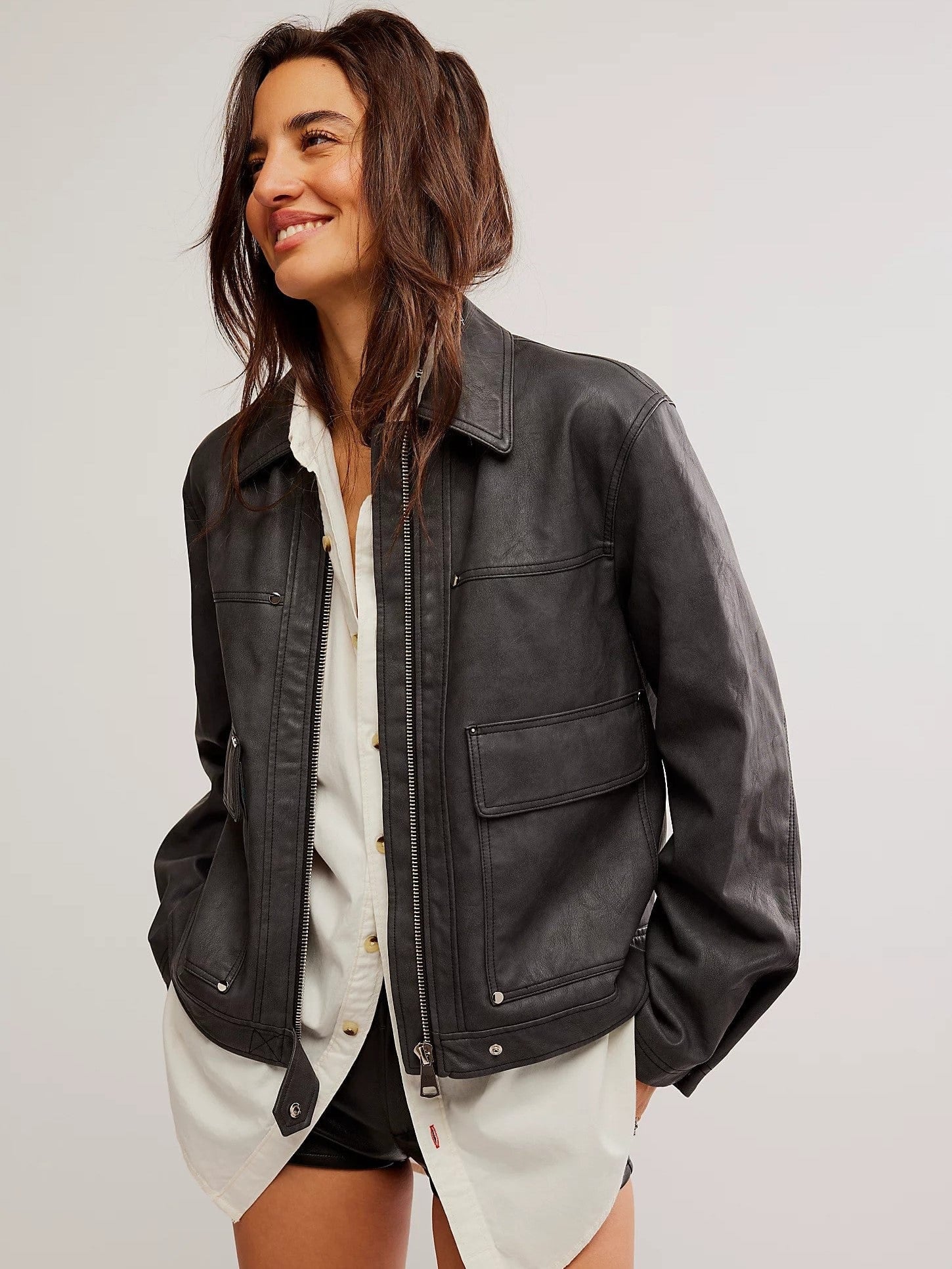 Free People Blaire Vegan Leather Jacket made from smooth, high-quality faux leather with a sleek, fitted design. This jacket features a zip-up front, classic collar, and minimalistic details, offering an edgy, versatile look that pairs perfectly with both casual and dressy outfits, Charcoal Combo