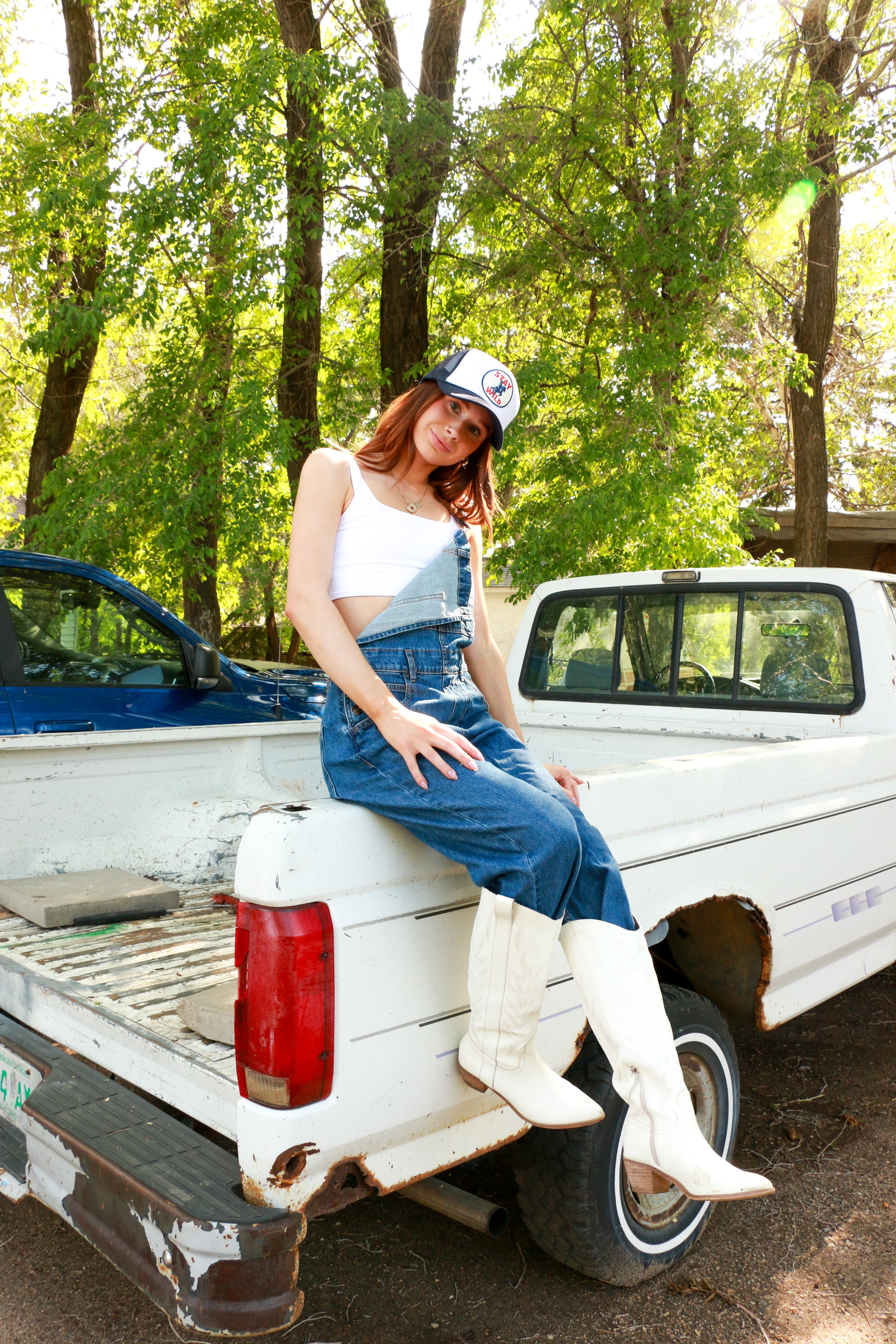 We The Free Ziggy Denim Overalls featuring a relaxed, vintage-inspired fit with wide legs and a distressed, worn-in look. The overalls have adjustable shoulder straps, a front bib pocket, and a button-up closure, offering both style and comfort for everyday wear, Sapphire Blue