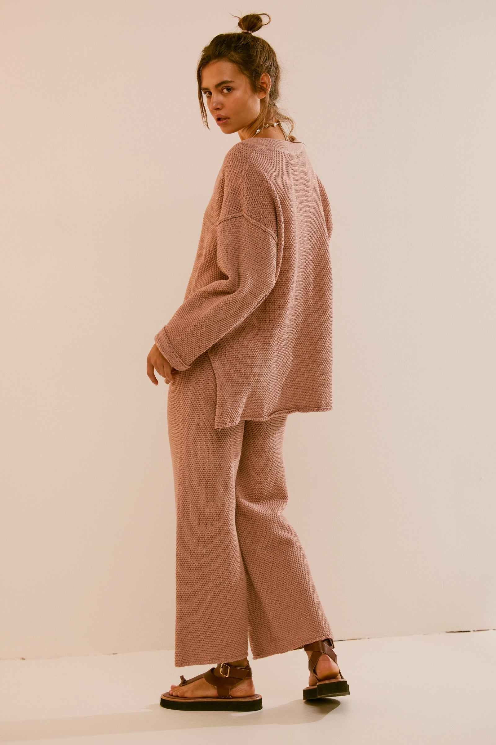 Free People Hailee Sweater Set featuring a soft, ribbed knit long-sleeve sweater and matching high-waisted, wide-leg pants. The relaxed fit of both pieces offers a comfortable and stylish look, perfect for lounging or casual outings, Tuscany