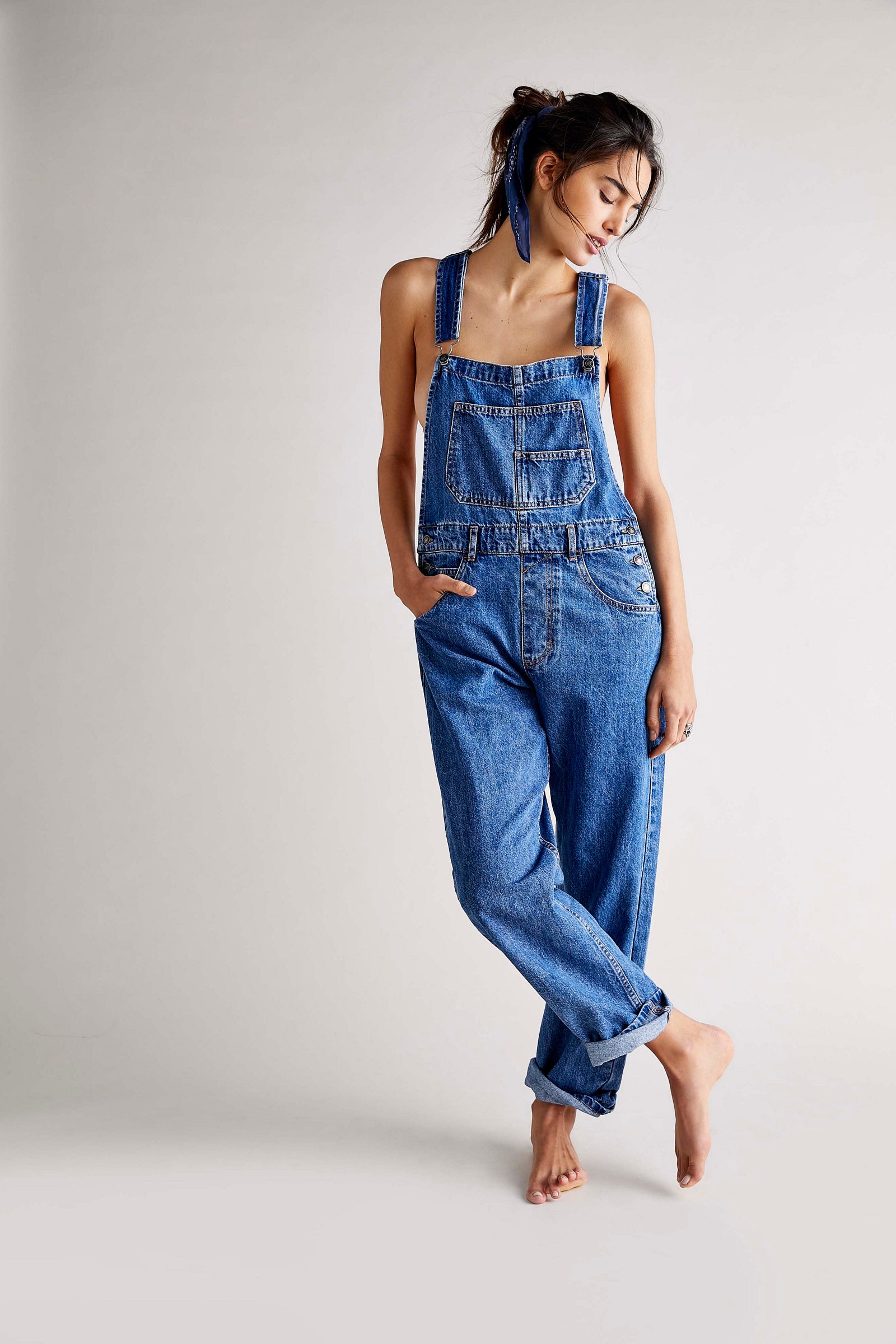 We The Free Ziggy Denim Overalls featuring a relaxed, vintage-inspired fit with wide legs and a distressed, worn-in look. The overalls have adjustable shoulder straps, a front bib pocket, and a button-up closure, offering both style and comfort for everyday wear, Sapphire Blue