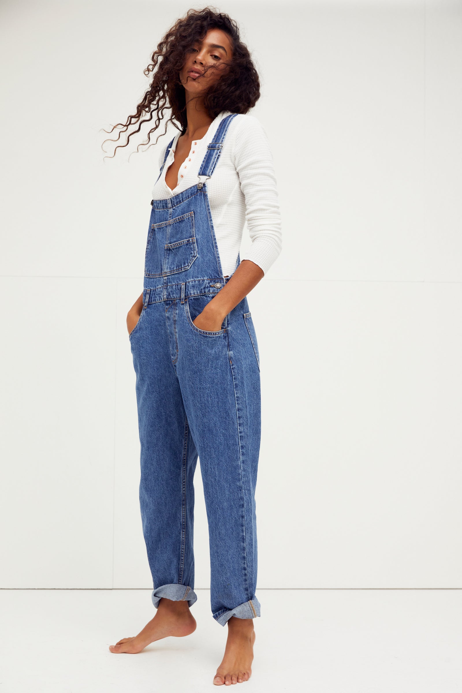 We The Free Ziggy Denim Overalls featuring a relaxed, vintage-inspired fit with wide legs and a distressed, worn-in look. The overalls have adjustable shoulder straps, a front bib pocket, and a button-up closure, offering both style and comfort for everyday wear, Sapphire Blue