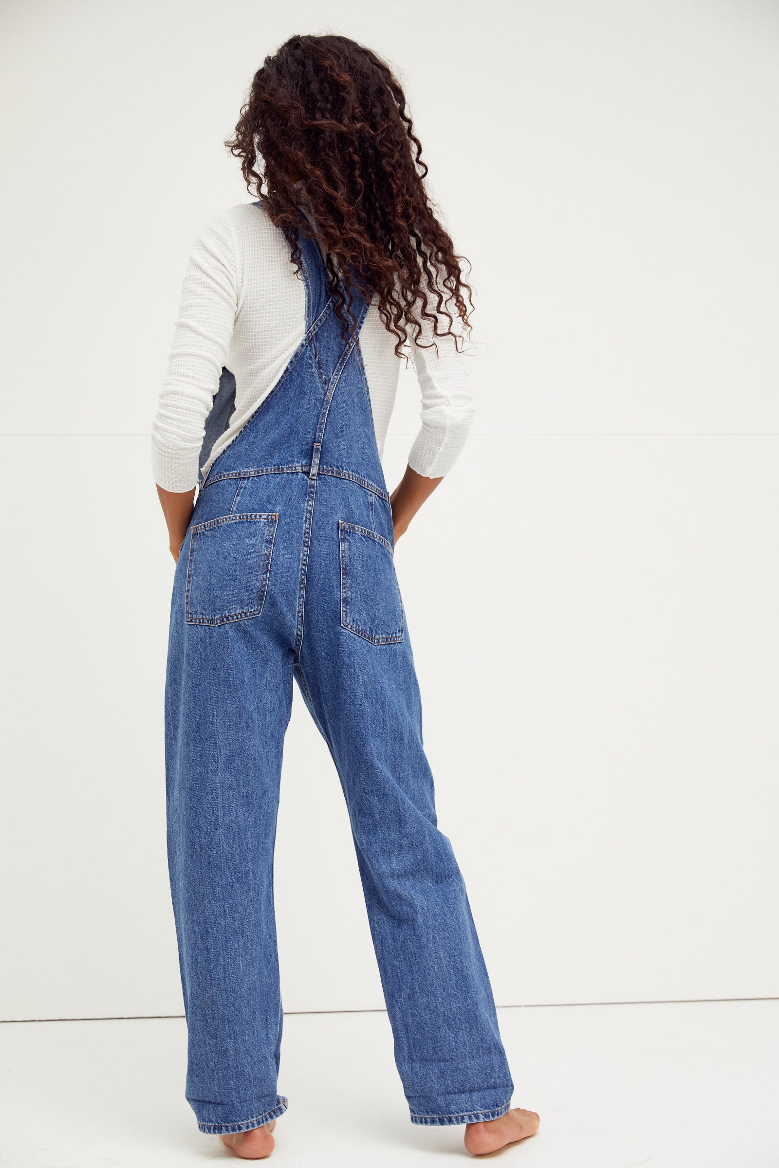 We The Free Ziggy Denim Overalls featuring a relaxed, vintage-inspired fit with wide legs and a distressed, worn-in look. The overalls have adjustable shoulder straps, a front bib pocket, and a button-up closure, offering both style and comfort for everyday wear, Sapphire Blue