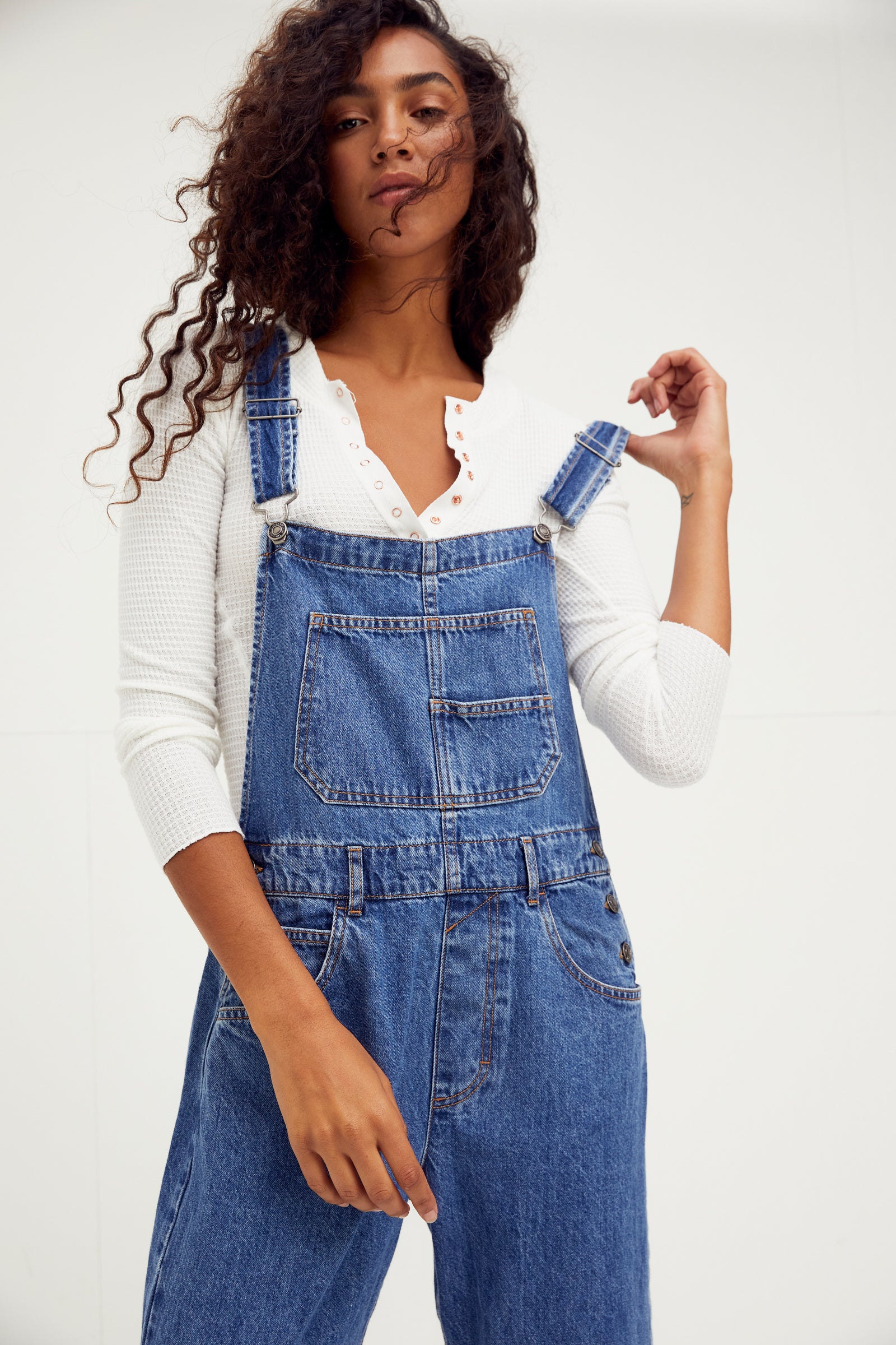 We The Free Ziggy Denim Overalls featuring a relaxed, vintage-inspired fit with wide legs and a distressed, worn-in look. The overalls have adjustable shoulder straps, a front bib pocket, and a button-up closure, offering both style and comfort for everyday wear, Sapphire Blue