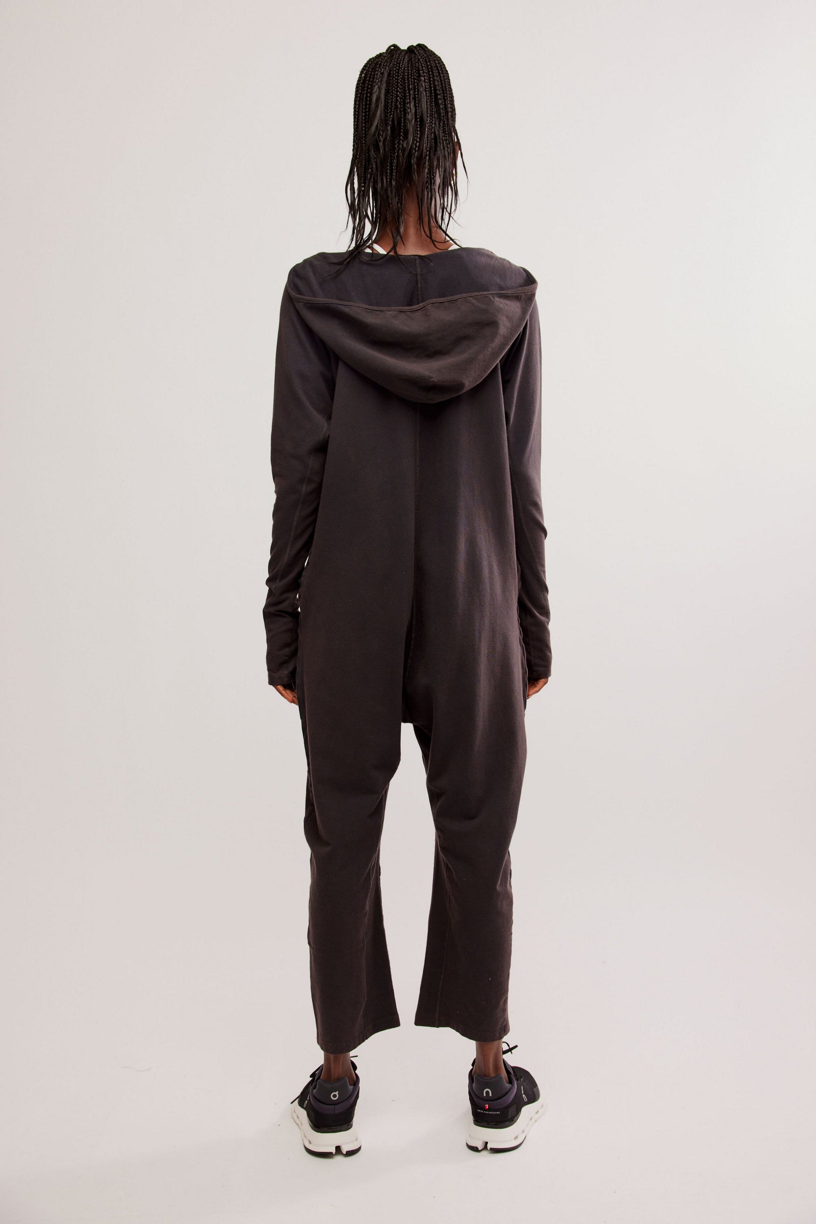 Free People Hot Shot Long Sleeve Onesie made from soft, stretchy fabric with a loose, relaxed design. This one-piece features a scoop neckline and long sleeves, offering a comfortable, laid-back fit that's perfect for layering or wearing on its own, Black