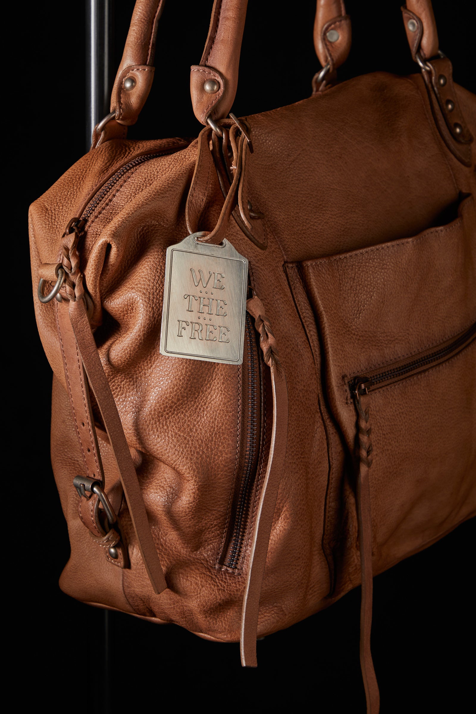 We the Free Emerson Tote Bag showcasing a spacious, simple design with sturdy handles, ideal for carrying essentials in style, Saddle