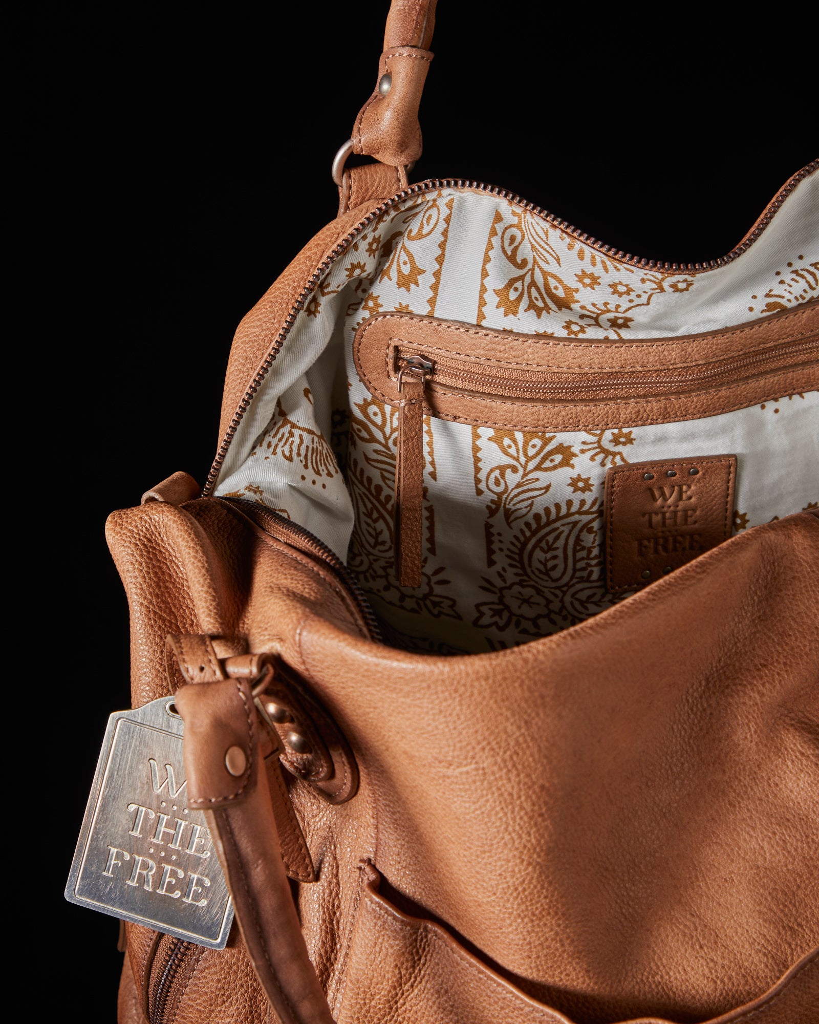 We the Free Emerson Tote Bag showcasing a spacious, simple design with sturdy handles, ideal for carrying essentials in style, Saddle