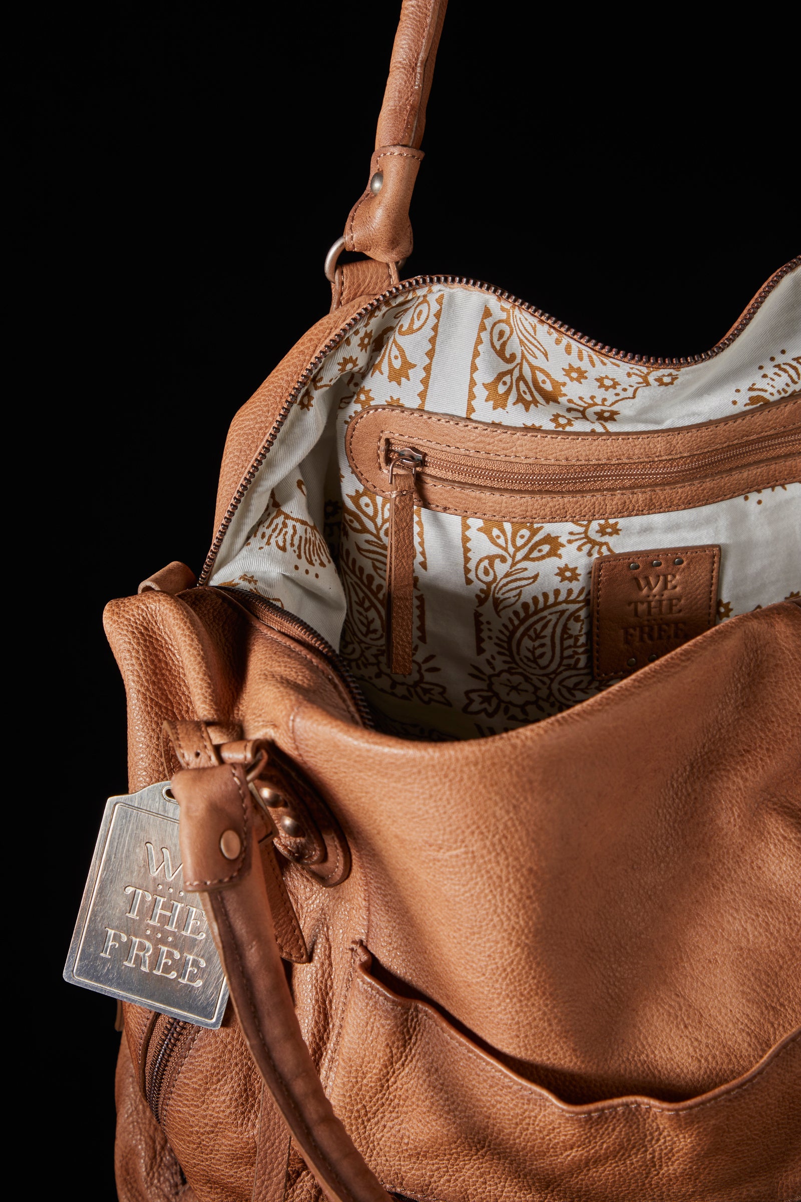 We the Free Emerson Tote Bag showcasing a spacious, simple design with sturdy handles, ideal for carrying essentials in style, Saddle