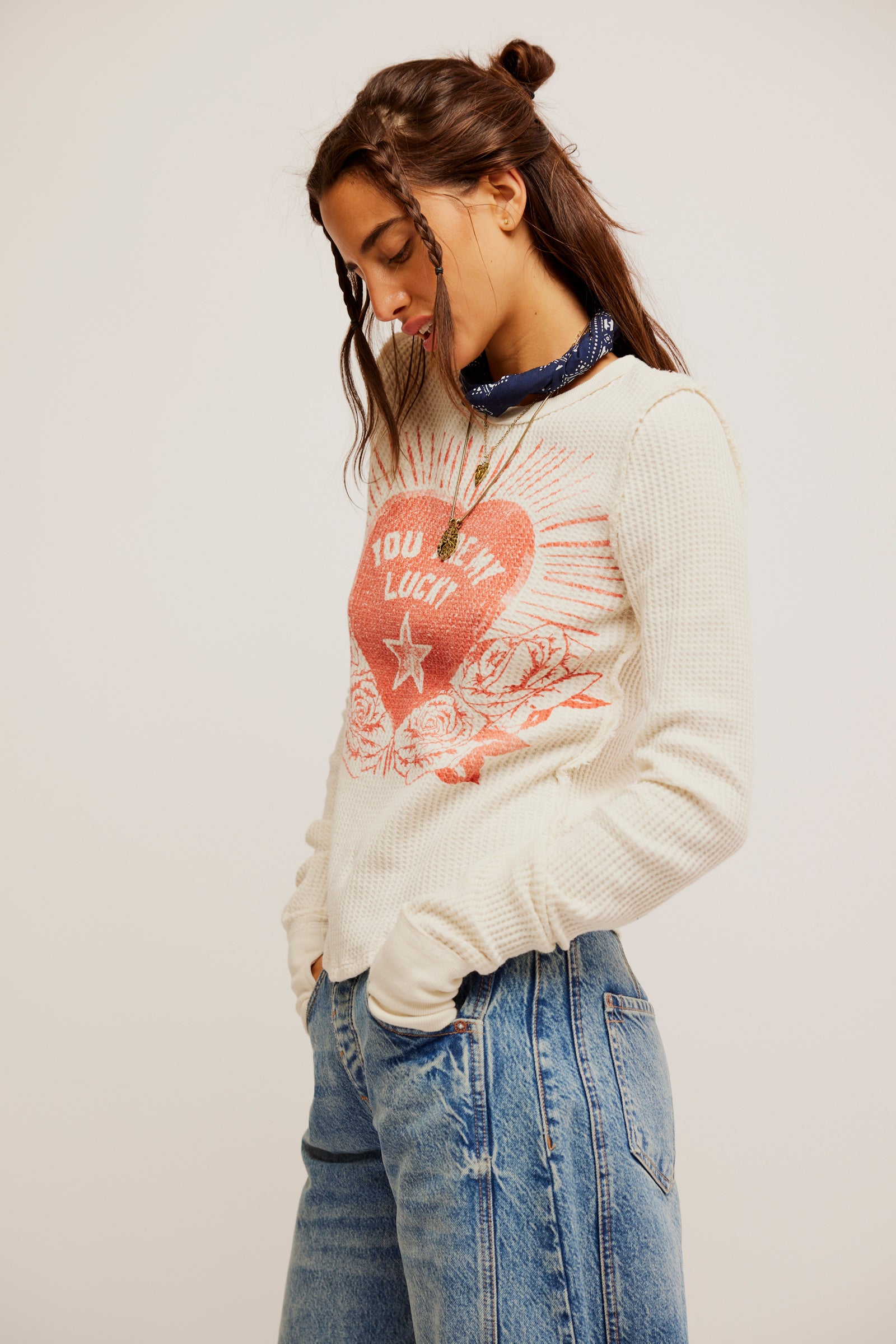 Free People Lucky Locket Tee made from soft, lightweight fabric with a relaxed fit. This short-sleeve tee features a scoop neckline and a unique graphic design with a locket-inspired print, Ivory