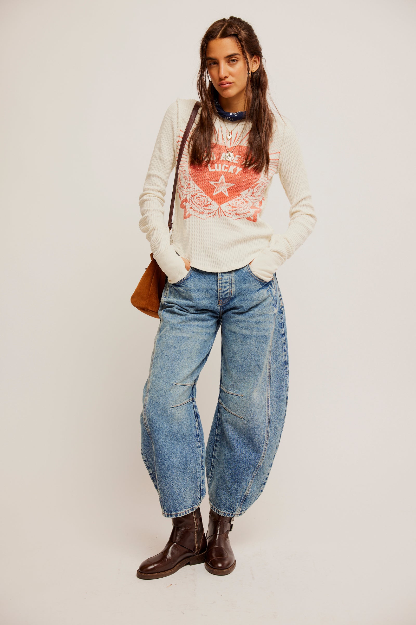 Free People Lucky Locket Tee made from soft, lightweight fabric with a relaxed fit. This short-sleeve tee features a scoop neckline and a unique graphic design with a locket-inspired print, Ivory