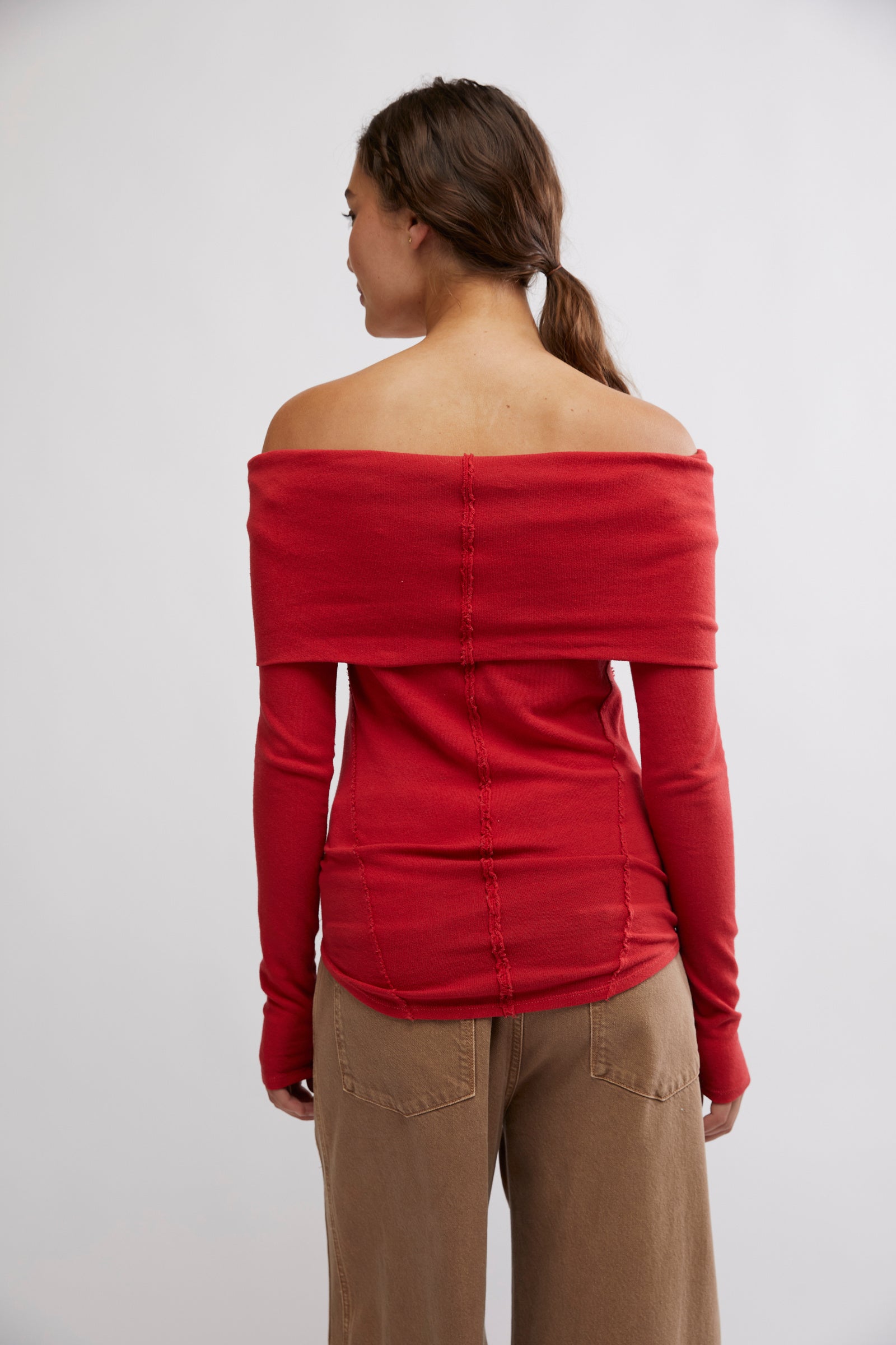 Free People Iris Layering Top made from soft, stretchy fabric with an off-the-shoulder design. This fitted long-sleeve top offers a sleek, minimalistic look, perfect for layering under jackets or sweaters for a cozy yet stylish feel, samba