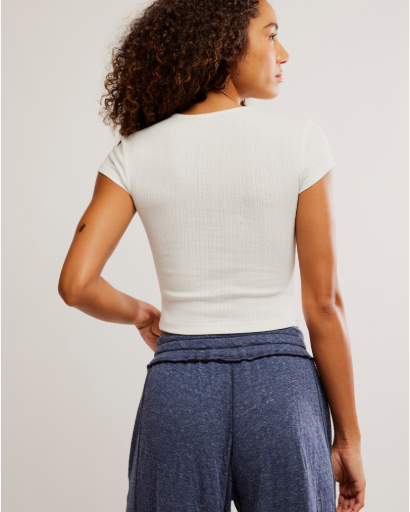 Free People Wait a Minute Baby Tee with a cropped, fitted design, short sleeves, and a soft, stretchy fabric, Oatmeal