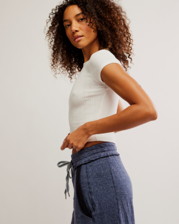 Free People Wait a Minute Baby Tee with a cropped, fitted design, short sleeves, and a soft, stretchy fabric, Oatmeal