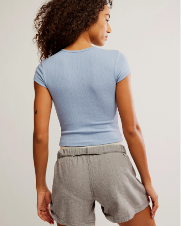 Free People Wait a Minute Baby Tee with a cropped, fitted design, short sleeves, and a soft, stretchy fabric, Soft Chambray