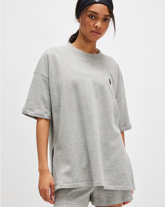 Free People Back Me Up Set – A relaxed, breathable two-piece set featuring a tunic-style top with side seam slits and a crew neckline, paired with high-rise shorts with side pockets and a dropped inseam, Heather Grey