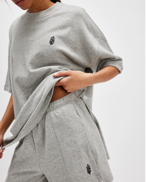 Free People Back Me Up Set – A relaxed, breathable two-piece set featuring a tunic-style top with side seam slits and a crew neckline, paired with high-rise shorts with side pockets and a dropped inseam, Heather Grey