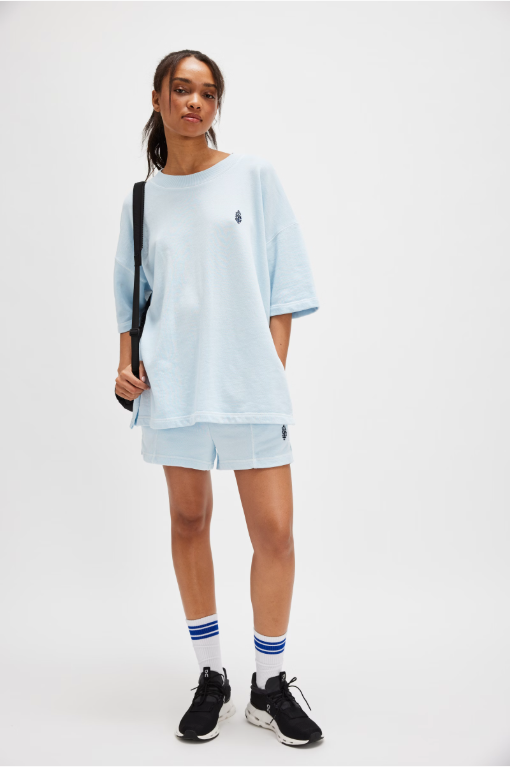 Free People Back Me Up Set – A relaxed, breathable two-piece set featuring a tunic-style top with side seam slits and a crew neckline, paired with high-rise shorts with side pockets and a dropped inseam, Baseline Blue