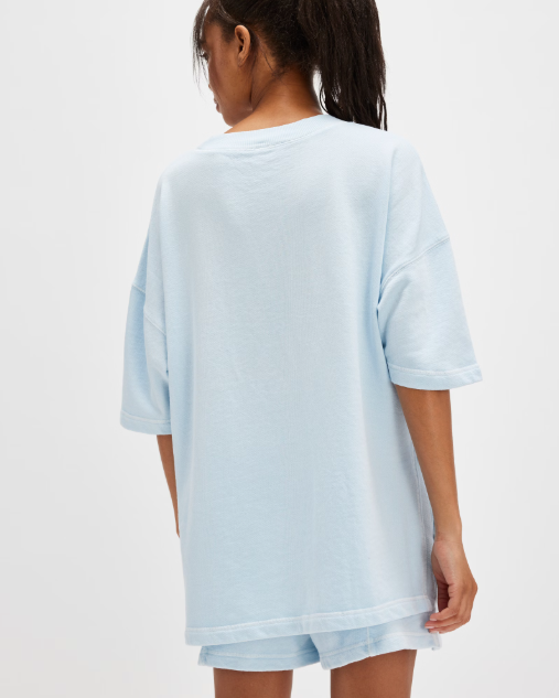 Free People Back Me Up Set – A relaxed, breathable two-piece set featuring a tunic-style top with side seam slits and a crew neckline, paired with high-rise shorts with side pockets and a dropped inseam, Baseline Blue