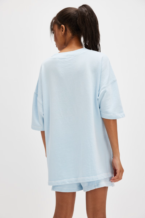 Free People Back Me Up Set – A relaxed, breathable two-piece set featuring a tunic-style top with side seam slits and a crew neckline, paired with high-rise shorts with side pockets and a dropped inseam, Baseline Blue