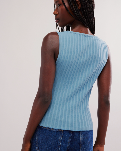 Free People Tilly Vest made from a soft, textured fabric with a relaxed, sleeveless design. This button-front vest offers a stylish and lightweight layering piece, perfect for adding a chic touch to any outfit, Ocean View