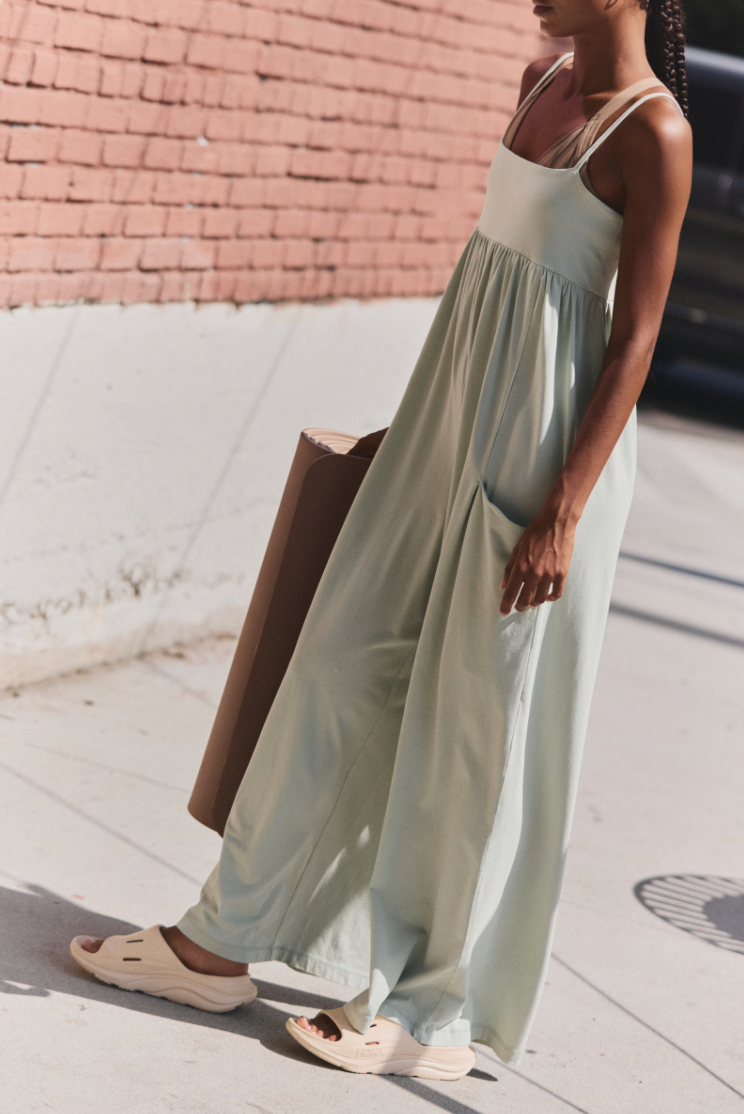 Free People Hot Shot Strappy Onesie, featuring soft cotton-blend fabric, simple shoulder straps, empire waist, and wide-leg slouchy fit, Green Tea