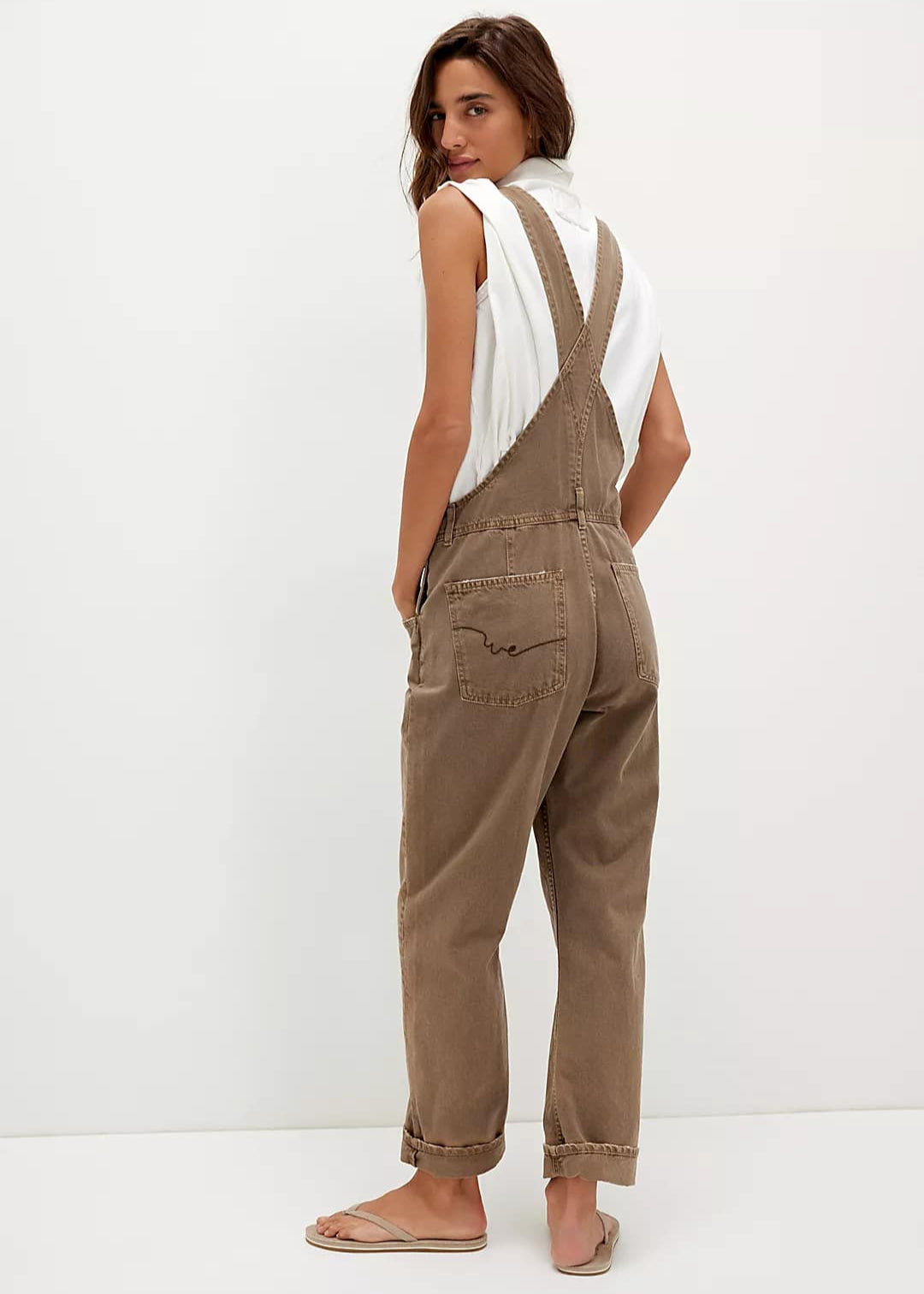 We The Free Ziggy Denim Overalls featuring a relaxed, vintage-inspired fit with wide legs and a distressed, worn-in look. The overalls have adjustable shoulder straps, a front bib pocket, and a button-up closure, offering both style and comfort for everyday wear, Cocoa