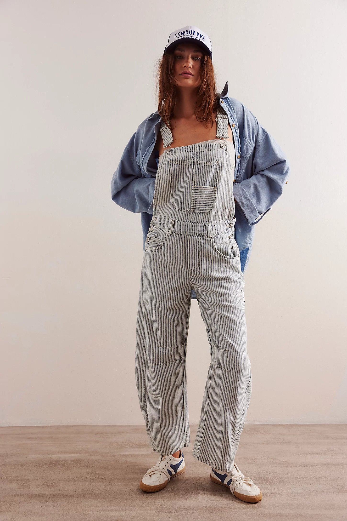 We The Free Good Luck Striped Barrel Overalls featuring a relaxed, cropped fit with a wide-leg silhouette. These overalls are designed with vertical stripes for a playful, vintage-inspired look, adjustable shoulder straps, and a button-front closure for a comfortable and stylish fit, Indigo Railroad