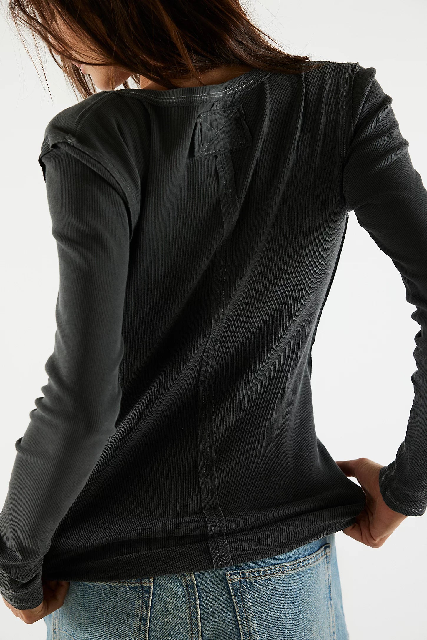 Free People Jamie Henley Top — a fitted, long-sleeve henley-style top featuring soft, stretchy ribbed fabric, a partial button-front closure, scoop neckline, and exposed seam details for a subtly textured, vintage-inspired look, Black