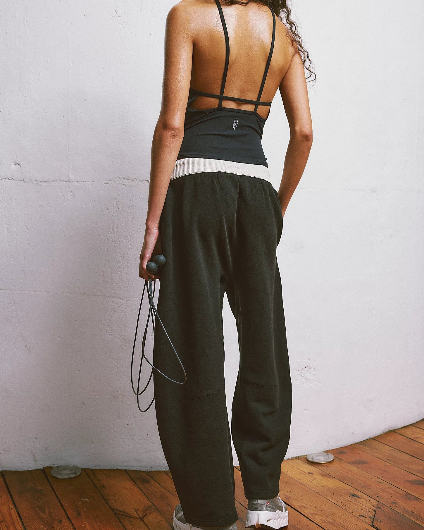 Free People You Wish Pant with a high-rise waist and unique barrel leg design, offering a comfortable and stylish look, Black