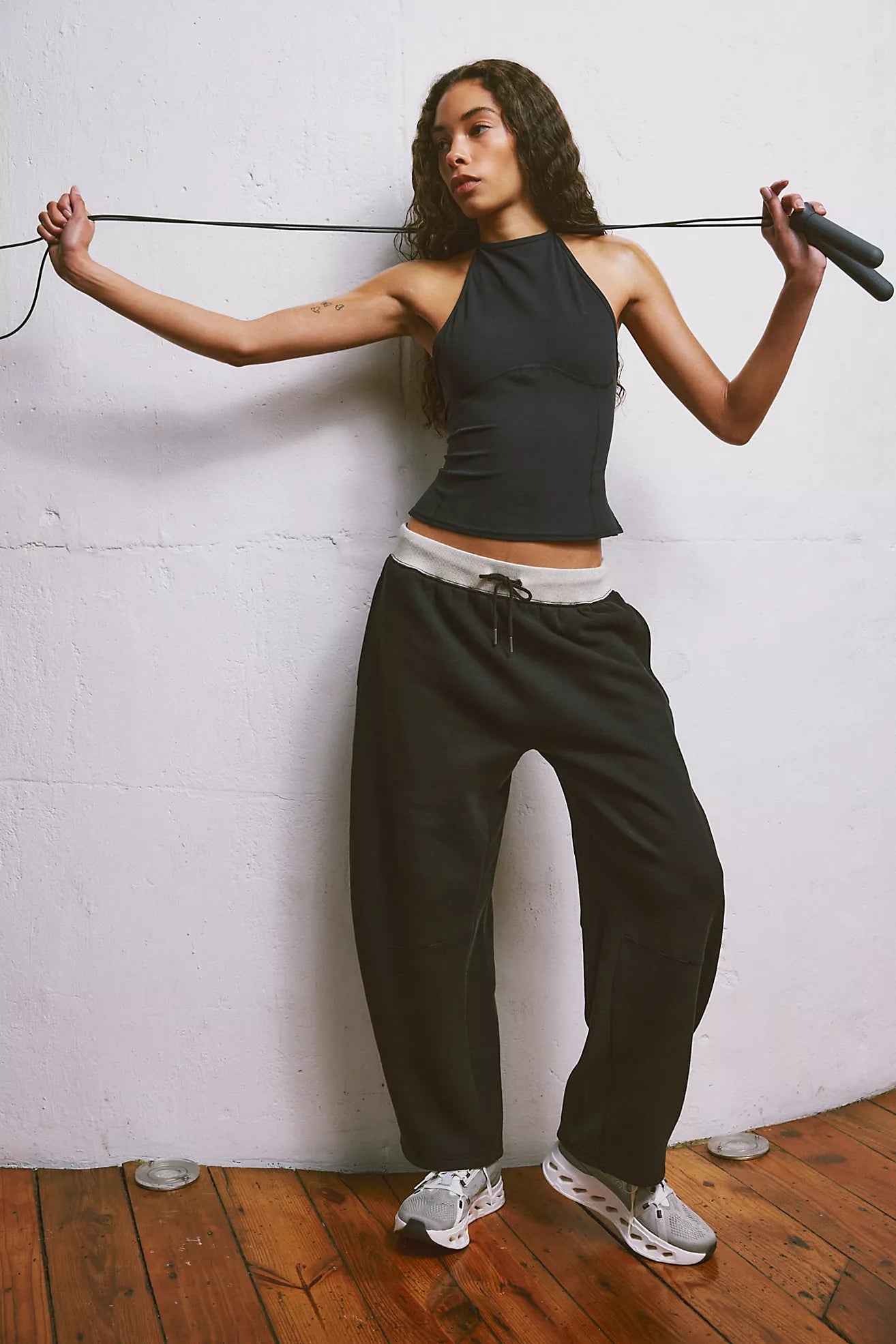 Free People You Wish Pant with a high-rise waist and unique barrel leg design, offering a comfortable and stylish look, Black