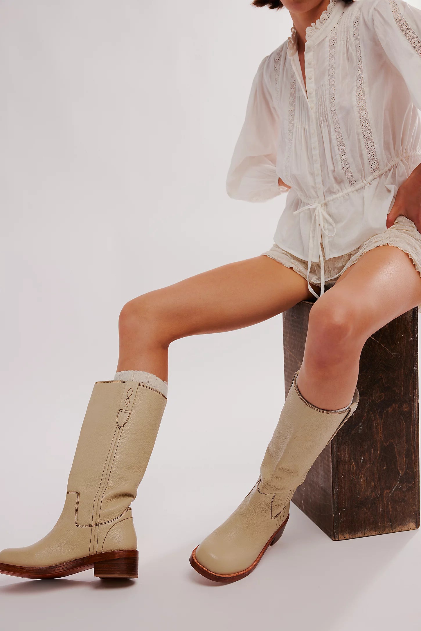 Free People Blaze Pull-On Boots featuring a tall silhouette, square toe, and stacked leather heel with distressed details, Parchment Leather