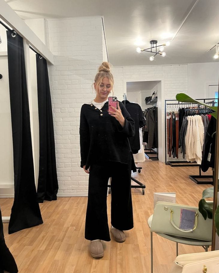 Free People Hailee Sweater Set featuring a soft, ribbed knit long-sleeve sweater and matching high-waisted, wide-leg pants. The relaxed fit of both pieces offers a comfortable and stylish look, perfect for lounging or casual outings, Black