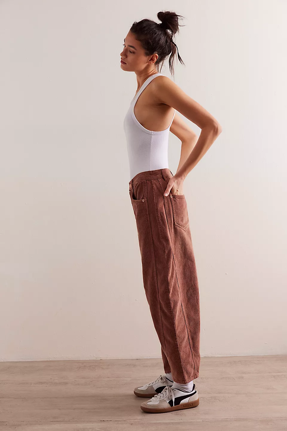Free People Good Luck Cord Barrel Jeans made from soft corduroy fabric with a relaxed, loose fit and wide-leg silhouette. These jeans offer a comfortable, vintage-inspired look with a laid-back style, Emperador