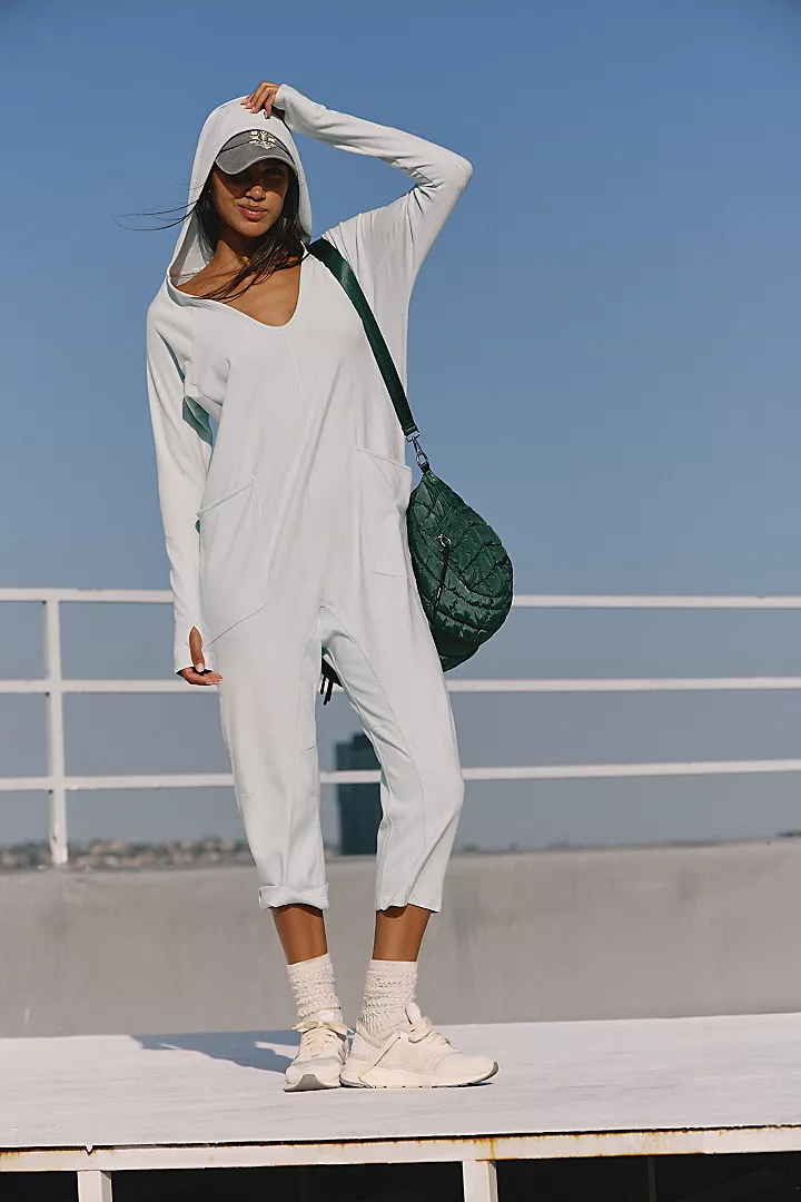 Free People Hot Shot Long Sleeve Onesie made from soft, stretchy fabric with a loose, relaxed design. This one-piece features a scoop neckline and long sleeves, offering a comfortable, laid-back fit that's perfect for layering or wearing on its own, Arctic Snow