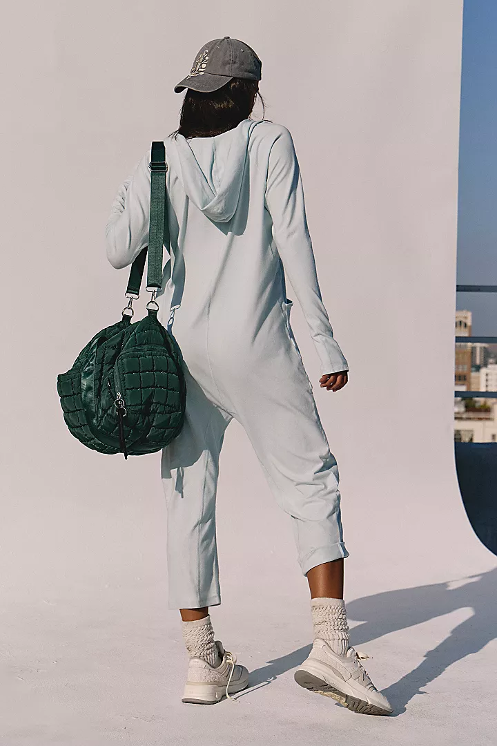 Free People Hot Shot Long Sleeve Onesie made from soft, stretchy fabric with a loose, relaxed design. This one-piece features a scoop neckline and long sleeves, offering a comfortable, laid-back fit that's perfect for layering or wearing on its own, Arctic Snow