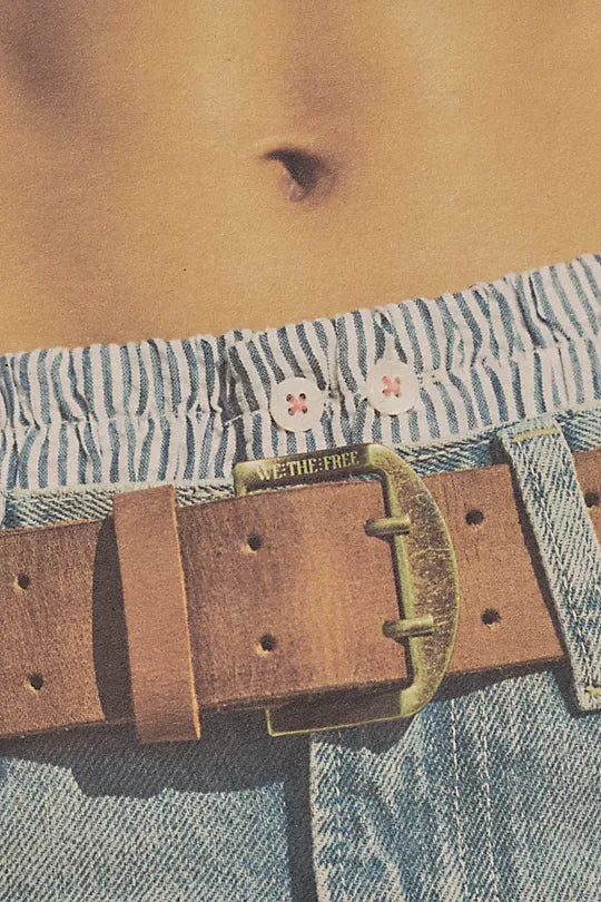 We The Free Double Cross Belt made from distressed leather with a bold, double-cross buckle design. This adjustable belt adds a rustic, boho-inspired touch to any outfit, perfect for pairing with jeans or dresses, Cognac