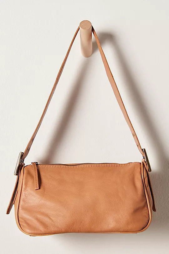 Free People Arm Candy Bag in luxe leather with a thick adjustable strap, rivet detailing, and a zip-top closure, Golden Coast