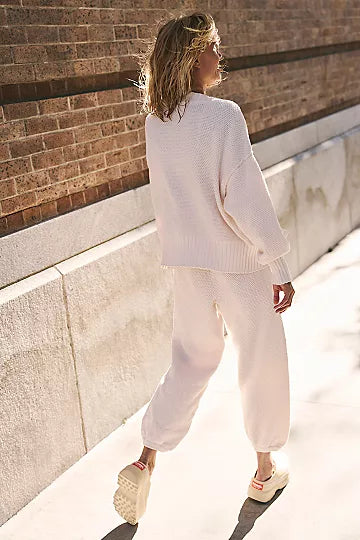 Free People Hailee Cardi Set featuring a soft, knit fabric with a relaxed fit. The set includes a long-sleeve, open-front cardigan and matching knit pants, offering a cozy and stylish look, perfect for casual wear or lounging, Powder Sand