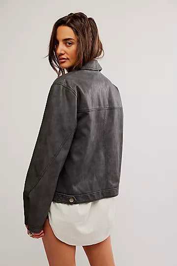 Free People Blaire Vegan Leather Jacket made from smooth, high-quality faux leather with a sleek, fitted design. This jacket features a zip-up front, classic collar, and minimalistic details, offering an edgy, versatile look that pairs perfectly with both casual and dressy outfits, Charcoal Combo