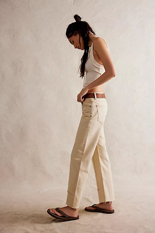 We The Free Risk Taker Mid-Rise Jeans made from soft denim with a relaxed fit and straight-leg silhouette. These jeans feature a mid-rise design, offering a casual, comfortable fit with a vintage-inspired look, Ecru