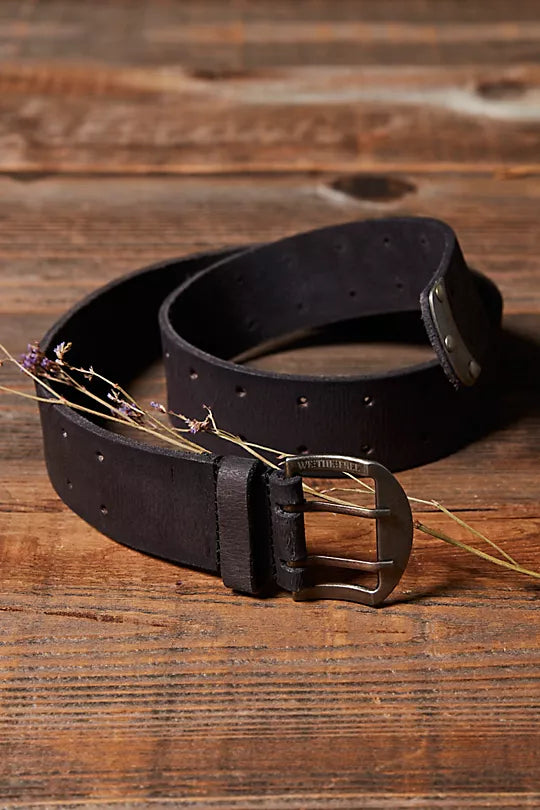 We The Free Double Cross Belt made from distressed leather with a bold, double-cross buckle design. This adjustable belt adds a rustic, boho-inspired touch to any outfit, perfect for pairing with jeans or dresses, Black
