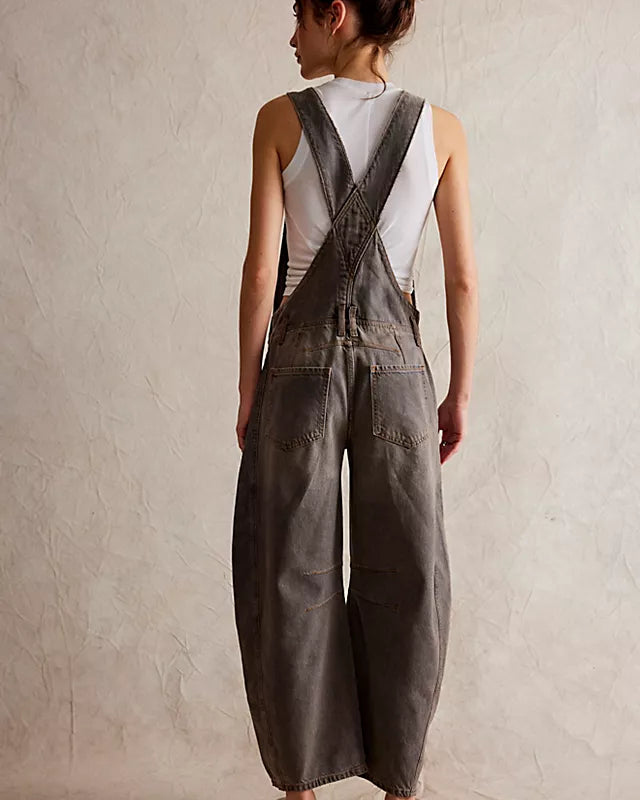 We The Free Good Luck Barrel Overalls with a relaxed, loose-fit design and wide-leg silhouette. These overalls feature adjustable straps and a soft, distressed denim fabric, offering a casual, boho-inspired look with a comfortable, laid-back feel, Archive Grey